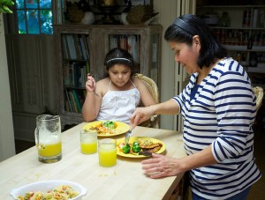 Esther Angeles, 41, with her daughter, Johanna Marisol Gomez, 7. Ms. Angeles has developed diabetes since coming to the United States and struggles to see that her daughter eats healthfully. Photo courtesy of The New York Times.