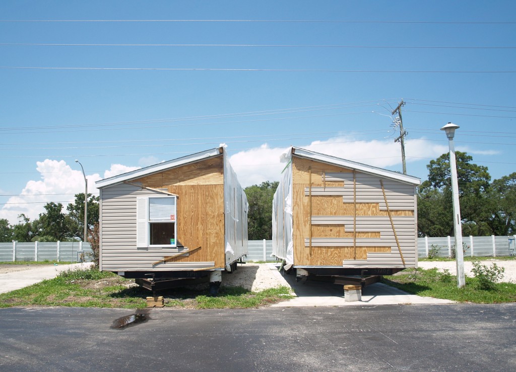 A double-wide home is split in preparation for it to be hauled out of a closing mobile home park in Florida. 